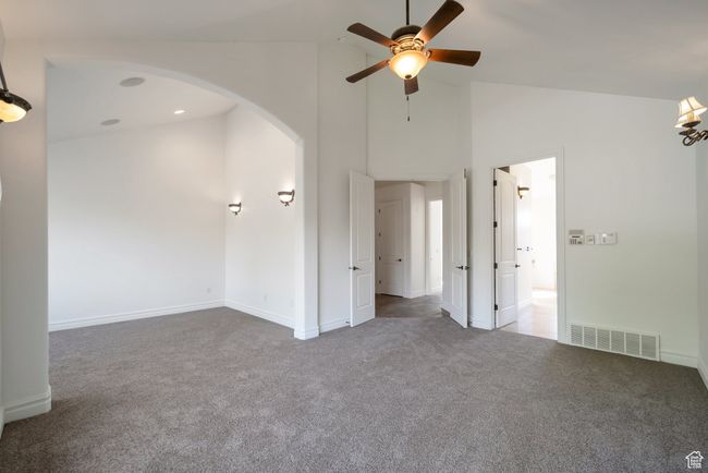 Primary bedroom with vaulted ceilings and a sitting area | Image 14