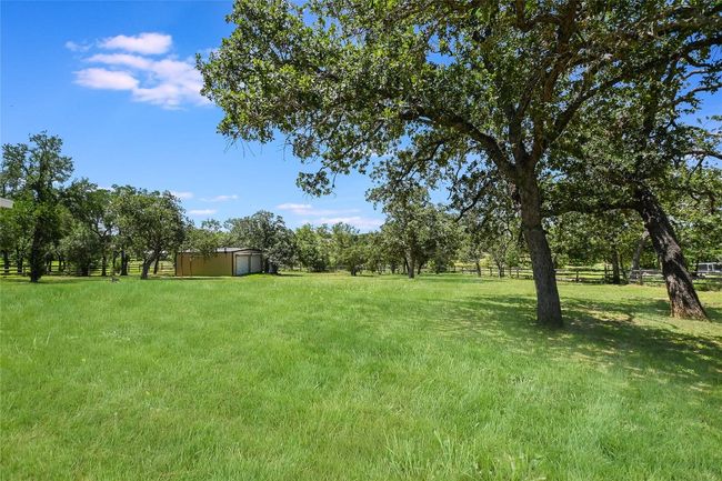 View of yard featuring a storage unit | Image 23