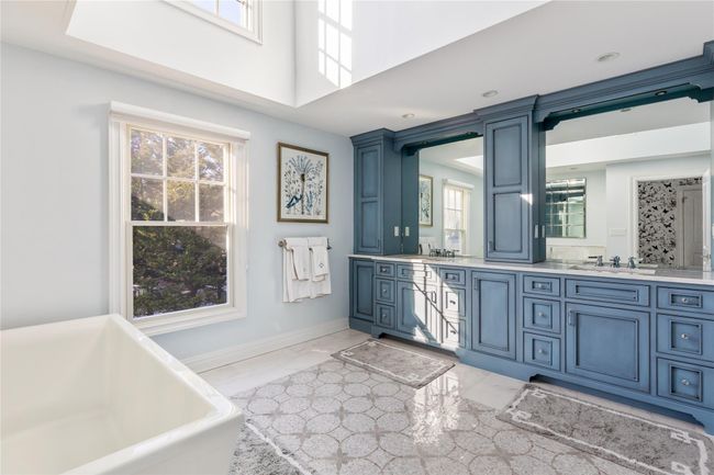 Bathroom with marble finish floor, a soaking tub, and plenty of natural light | Image 31
