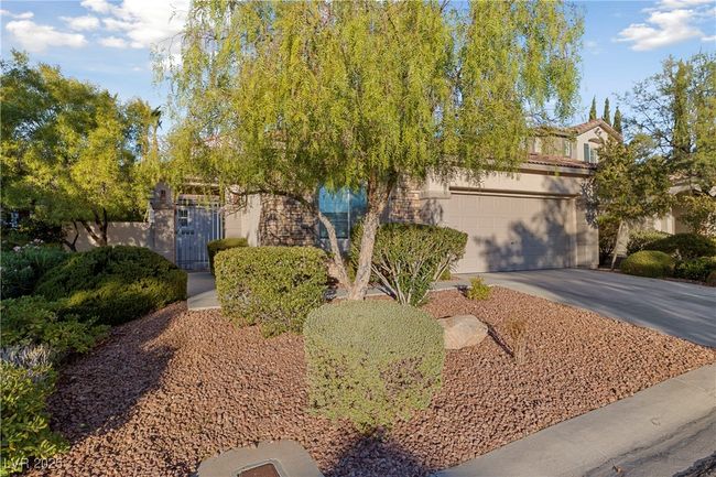 Obstructed view of property featuring driveway and stucco siding | Image 8