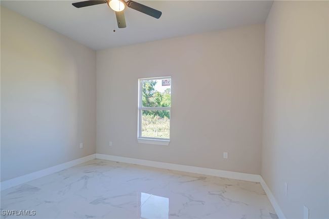 Unfurnished room with marble finish floor, baseboards, and ceiling fan | Image 15