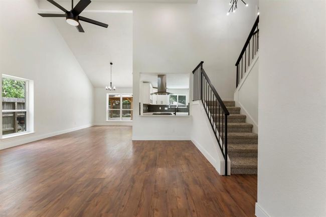 Gleaming luxury vinyl plank flooring, soaring ceilings, and impressive updates greet you as you enter the home. | Image 4