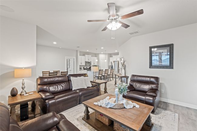 Living room featuring baseboards, visible vents, light wood-style flooring, recessed lighting, and ceiling fan | Image 9