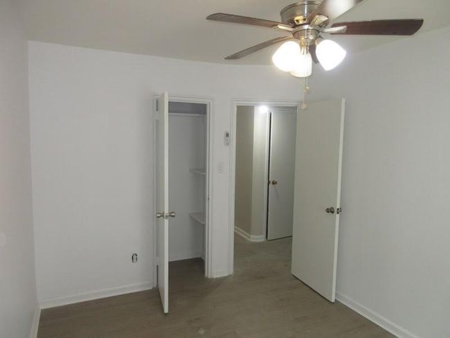 Unfurnished bedroom with baseboards, a ceiling fan, and light wood-style floors | Image 11