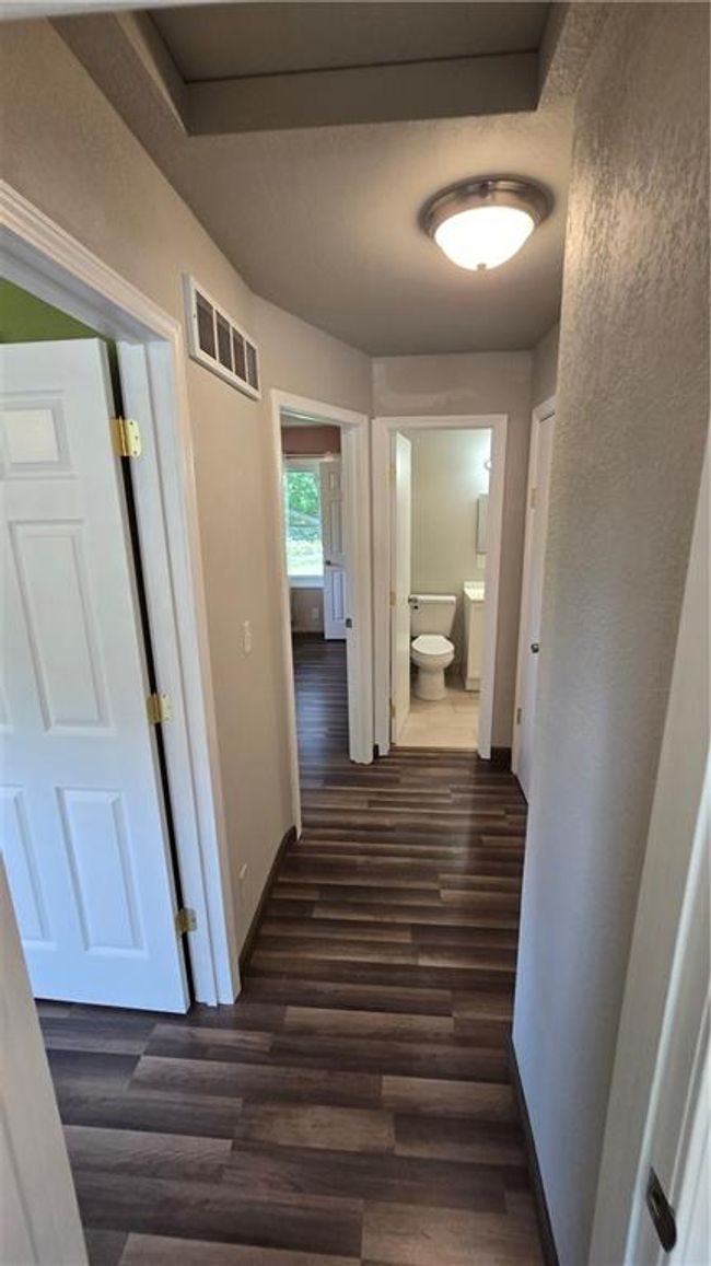 Upper level hallway view to Bath2, stairs, & bedrooms | Image 15