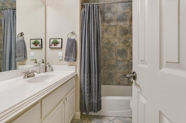 UPSTAIRS Full hall bathroom with vanity, shower / bathtub combination, and tile patterned floors. Located just off the Family Room/Game Room. | Image 27