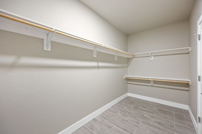 Walk in closet featuring wood finished floors | Image 14