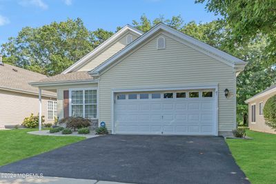 Ideally located in the Heritage Bay 55+ Community, this lovely home features brick and vinyl siding and a two car garage. There are 9 foot ceilings throughout, pull down attic access in the garage. | Image 3