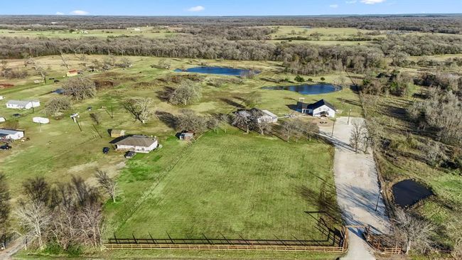 Another aerial view showcases the property’s wide-open land, and thoughtful layout. Plenty of room to build your dream home! | Image 44