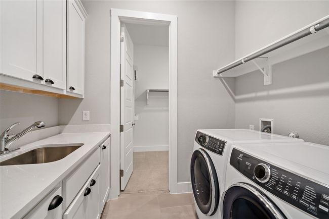 The laundry room is tied into the master closet for convenience. | Image 27