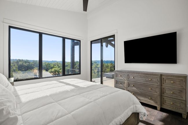 Sliding doors lead to the patio and provide additional natural light & sweeping views. | Image 11
