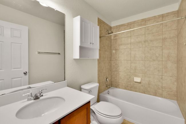 Bathroom with bathtub / shower combination, vanity, and toilet | Image 18