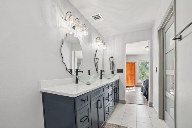 Full bathroom featuring double vanity and marble finished flooring | Image 20
