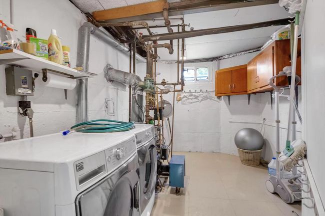 Washroom with washing machine and dryer and cabinet space | Image 14