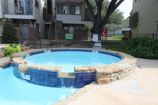 View of pool with a pool with connected hot tub, fence, and stairs | Image 24