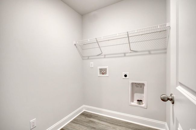 Laundry room featuring hookup for a washing machine, wood-type flooring, and hookup for an electric dryer | Image 29