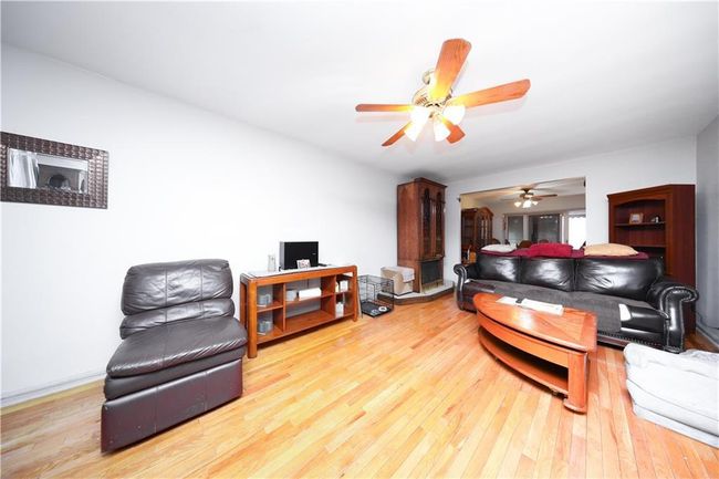 Living room with hardwood / wood-style floors, ceiling fan, and a desk | Image 7