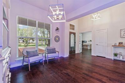 Formal Dining room area used as a living area with hardwood flooring. | Image 2