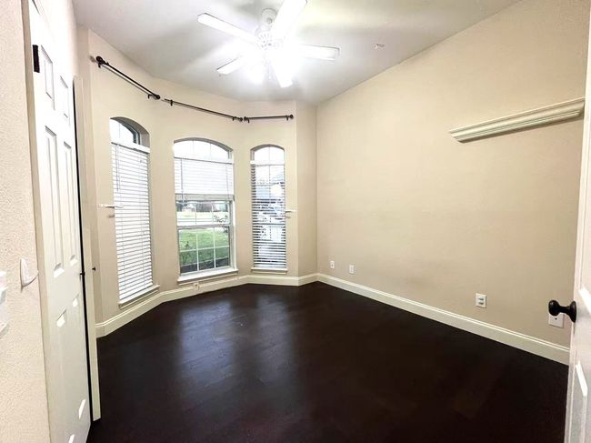 Empty room with dark wood-style flooring and a ceiling fan | Image 25