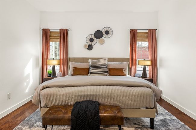 Bedroom with multiple windows and wood finished floors | Image 14
