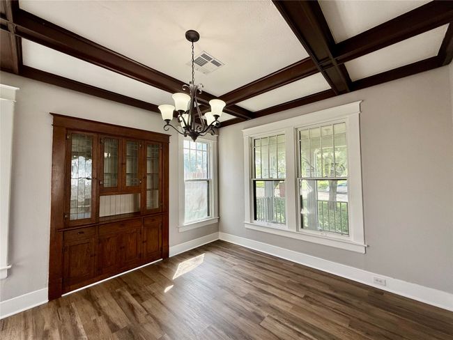 Foyer featuring a chandelier, beamed ceiling, dark wood finished floors, and coffered ceiling | Image 5