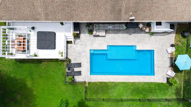 Outdoor entertainer’s paradise featuring new pool, inviting al fresco dining area, cool shaded patio, and relaxing hot tub — perfect for hosting or unwinding in style | Image 8
