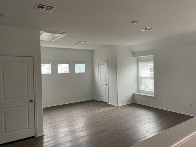 Empty room featuring attic access, dark wood-type flooring, and baseboards | Image 10