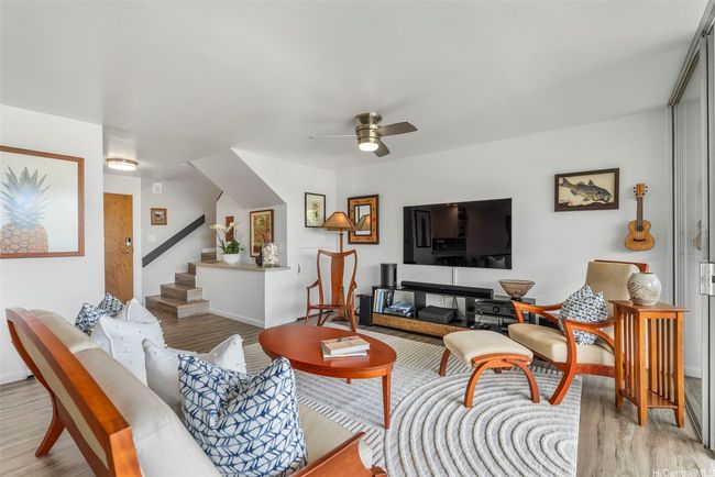 A spacious living area accommodates several pieces of furnishings comfortably. | Image 4