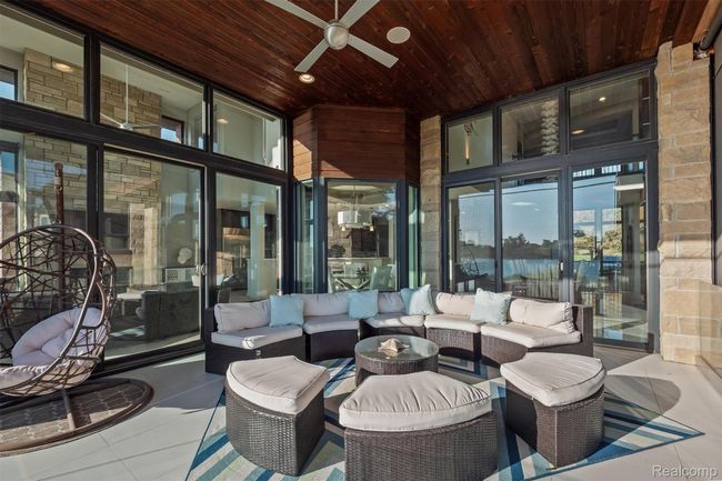 View of patio featuring an outdoor living space and a ceiling fan | Image 54