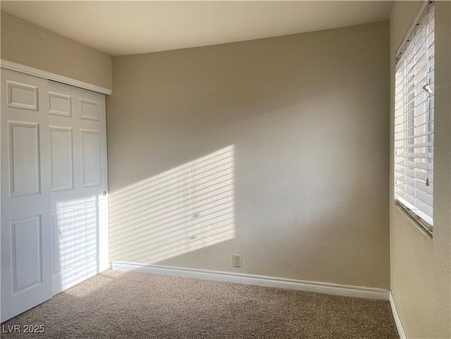 Unfurnished bedroom with a closet, baseboards, and carpet flooring | Image 11