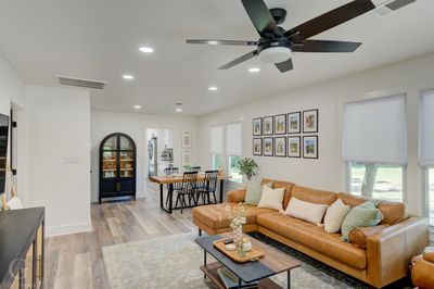 Living room featuring light wood-type flooring and ceiling fan | Image 3