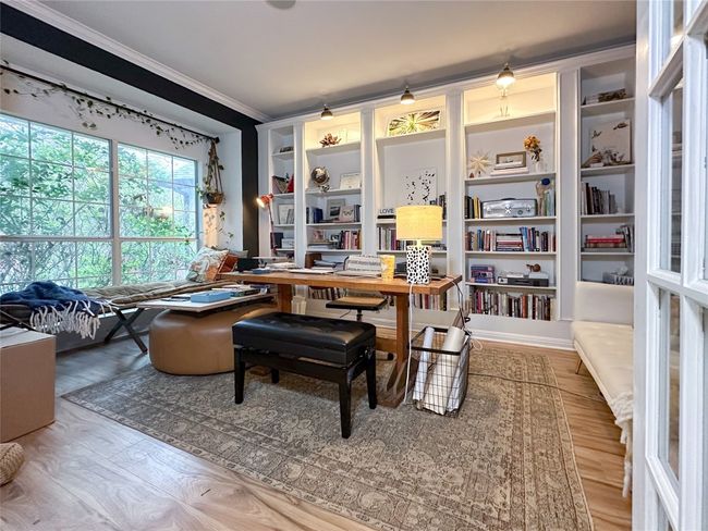 Office space with ornamental molding, wood finished floors, and built in features | Image 6