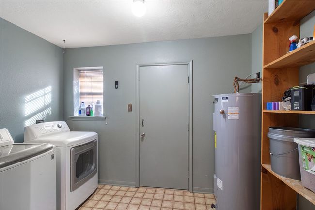 Laundry area featuring water heater and separate washer and dryer | Image 29