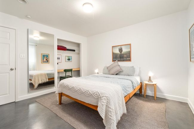 Bedroom featuring finished concrete floors and baseboards | Image 14