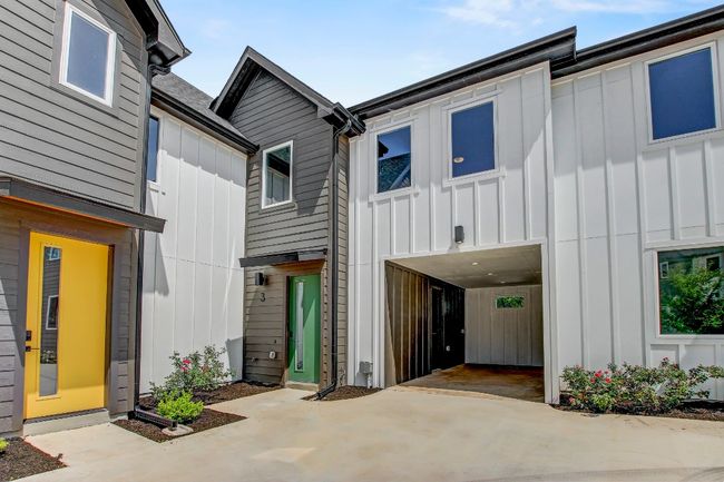 View of front of house with board and batten siding and driveway | Image 26