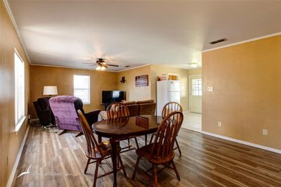 Dining room with new laminate flooring and ornamental molding. | Image 3