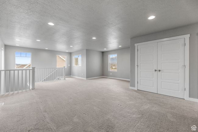 Spare room featuring carpet, a textured ceiling, and recessed lighting | Image 24