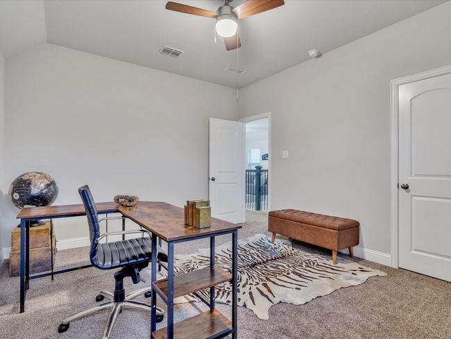 Carpeted home office with ceiling fan and lofted ceiling | Image 22