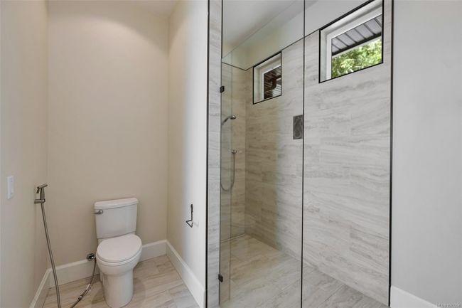 Bathroom with a tile shower and toilet | Image 83