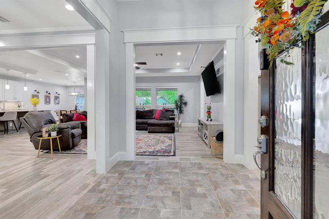 A captivating layout offering a seamless flow from the inviting entryway to the spacious living area, designer kitchen, and versatile flex space. | Image 9