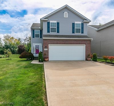 View of front property featuring a garage and a front lawn | Image 1