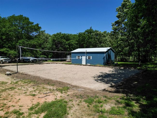 View of property's community with volleyball court and an outdoor structure | Image 27