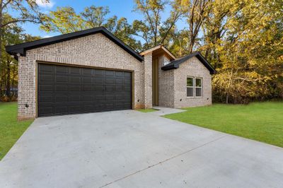 Single story home with a garage and a front lawn | Image 2