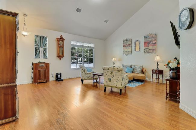 Large Living area with light wood-style flooring and high vaulted ceiling | Image 7