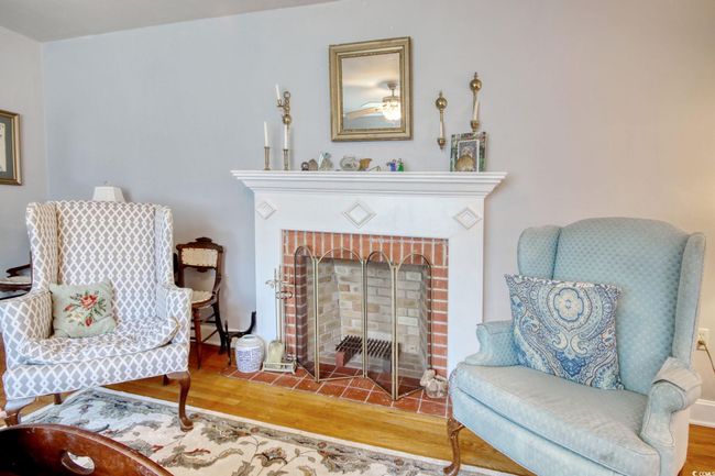 Sitting room featuring wood finished floors and a fireplace | Image 15