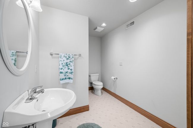 bathroom with a sink, tile patterned floors, toilet, visible vents, and baseboards | Image 104