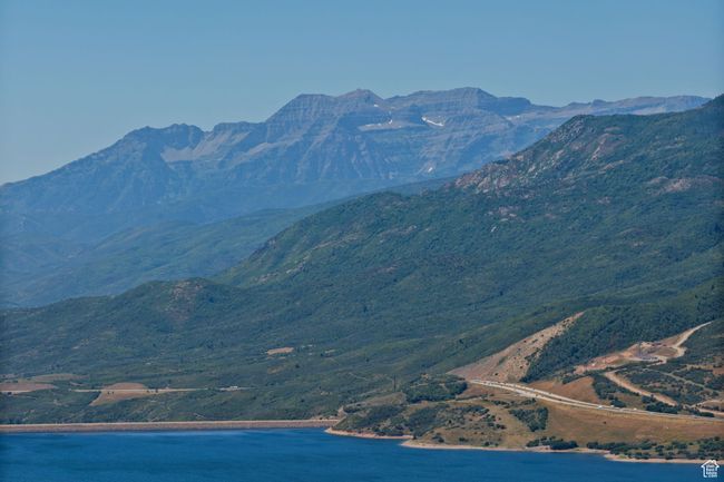View of mountain background featuring a nearby body of water | Image 16