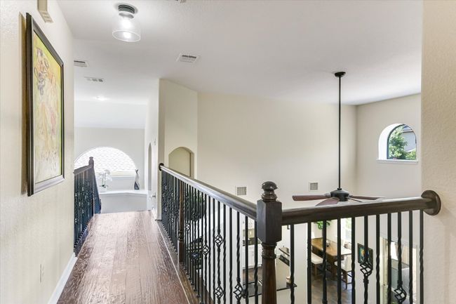 Upstairs hallway gives you a view of downstairs as well as pool. | Image 15