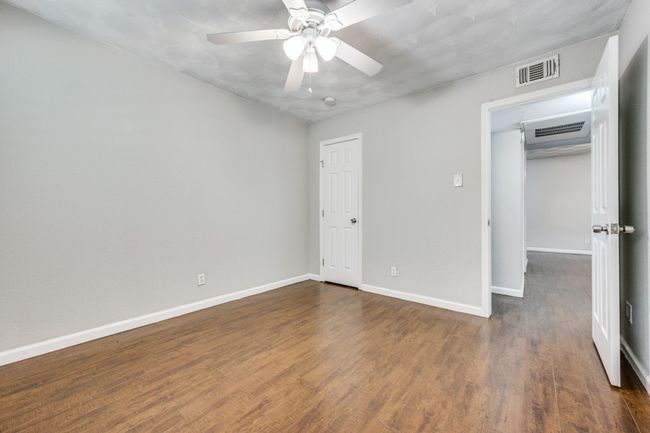 Unfurnished bedroom featuring wood finished floors and a ceiling fan | Image 12