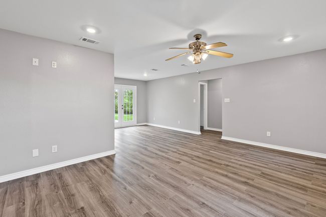 Living room featuring ceiling fan, wood finished floors, and recessed lighting | Image 11